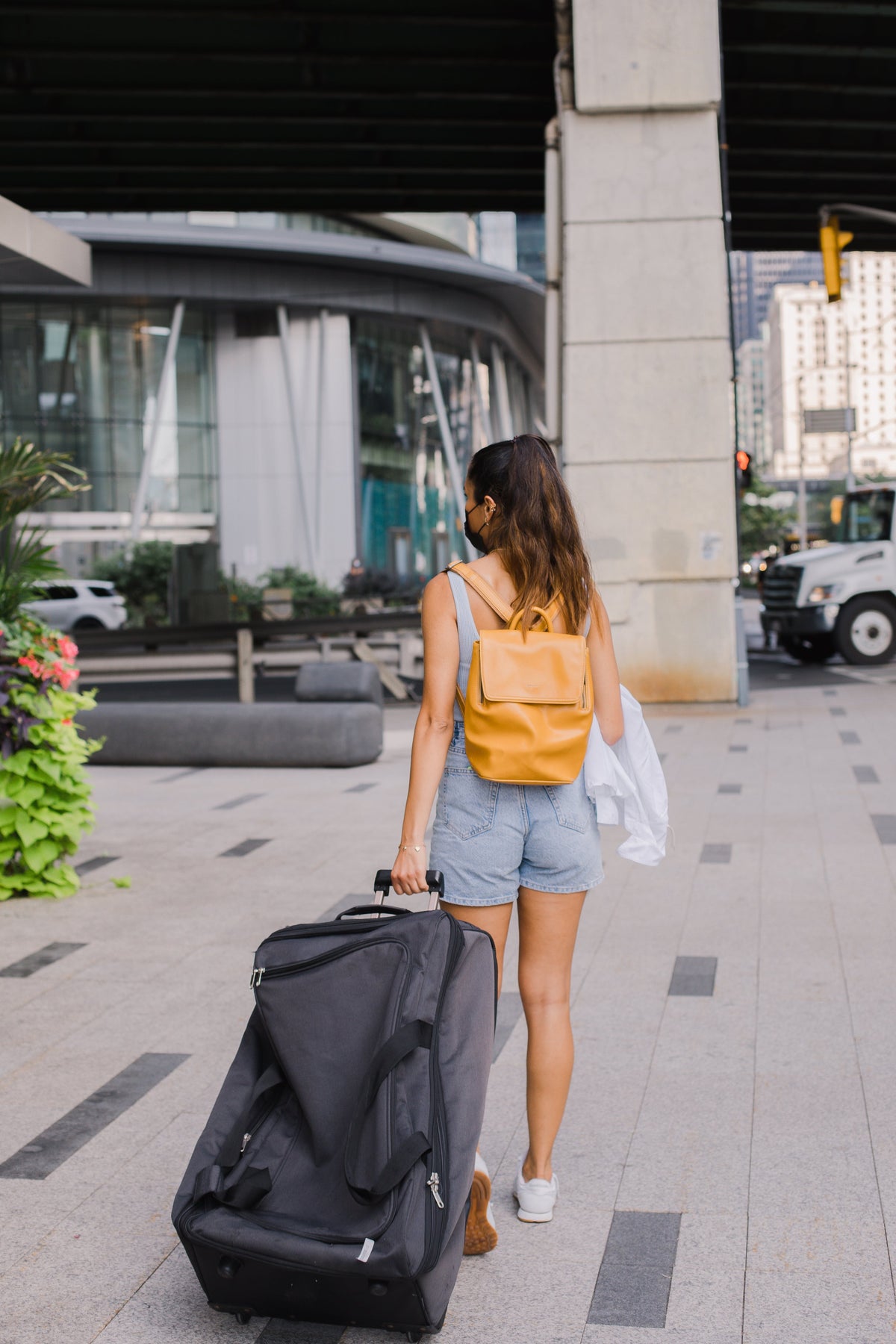 walking-away-from-the-camera-pulling-a-large-suitcase