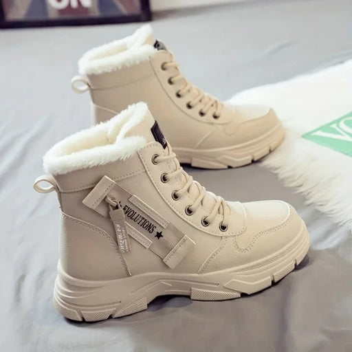 Beige winter boots with fur lining on a light gray surface