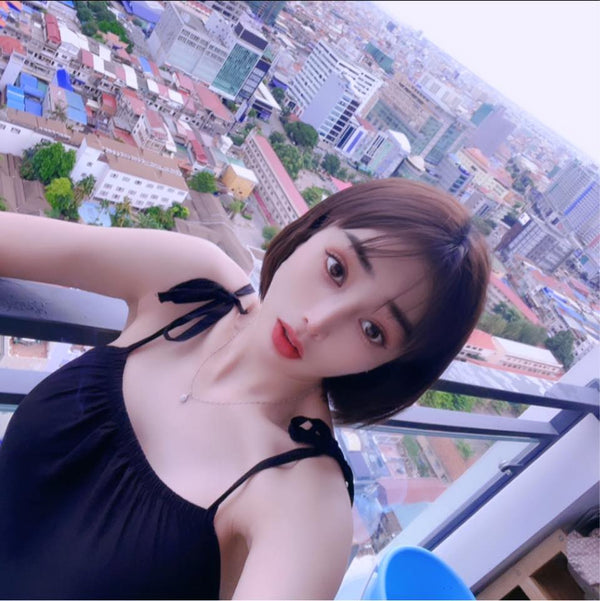 Woman taking a selfie with a cityscape in the background