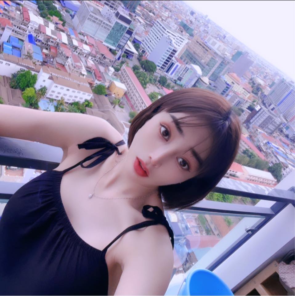Woman taking a selfie with a cityscape in the background