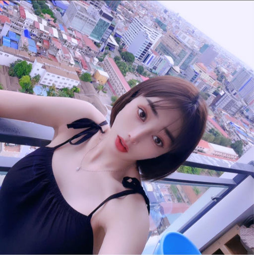 Woman taking a selfie with a cityscape in the background