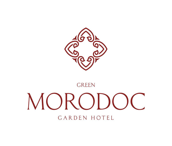 Logo of Green Morodoc Garden Hotel with decorative emblem on a white background