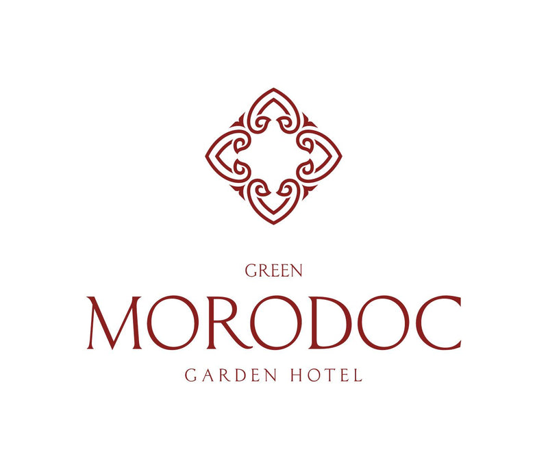 Logo of Green Morodoc Garden Hotel with decorative emblem on a white background