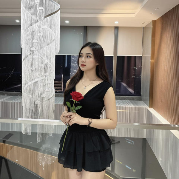Woman holding a red rose in an indoor setting with modern decor