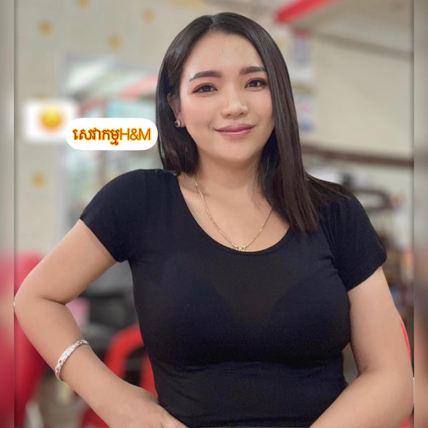 Woman wearing a black top with H&M logo in the corner