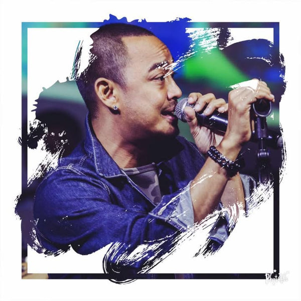 Person holding a microphone with artistic background