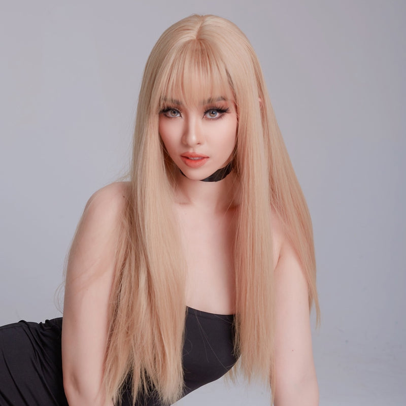 Person with long blonde wig on a plain background