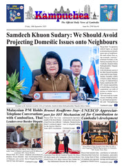 Newspaper front page with a woman and man at a podium, featuring international news headlines.