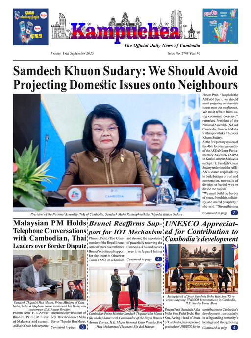 Newspaper front page with a woman and man at a podium, featuring international news headlines.