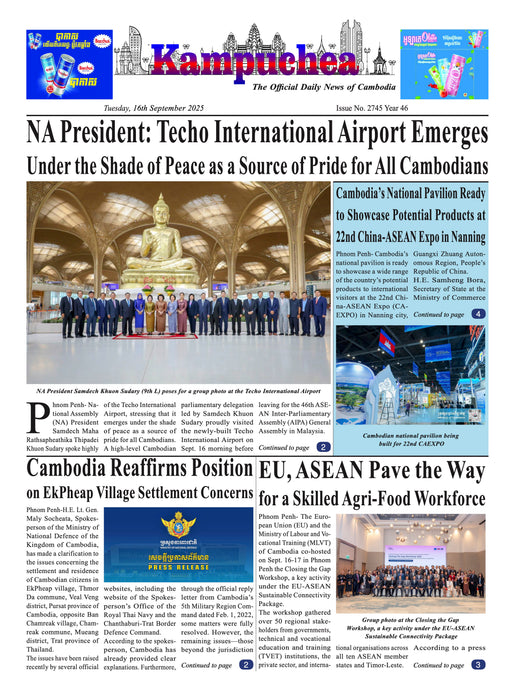 Newspaper front page with a large photograph of a statue and a group of people, with text about Cambodia and its President.