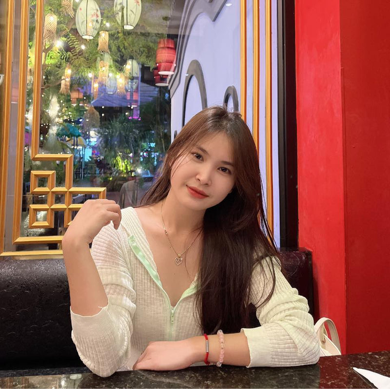 Woman sitting at a table in a restaurant with colorful decor