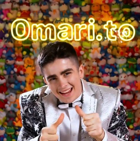 Person in a sequined jacket giving a thumbs-up gesture with 'Omari.to' text in the background