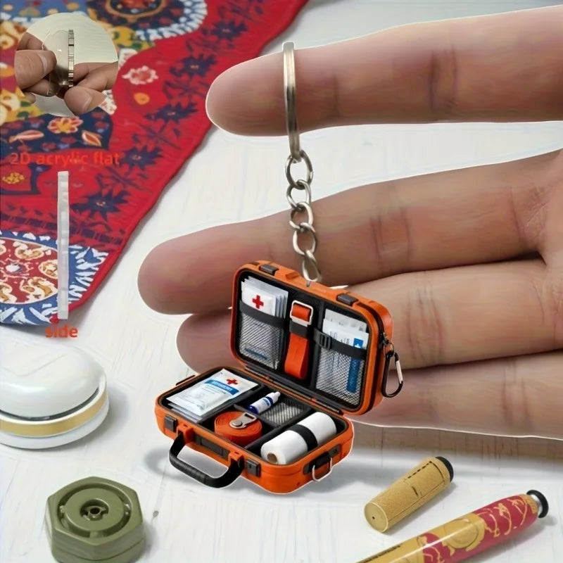 1pc 2D Flat Proportional First Aid Kit Keychain,Compact and Portable Care with CPR Guide Symbols,Bandage and Patch Compatible.