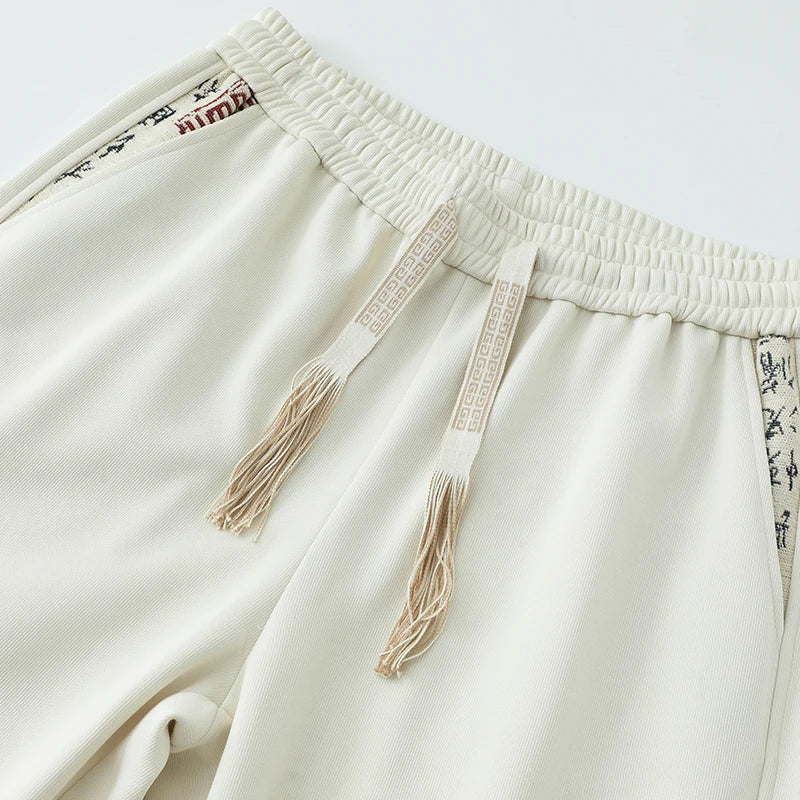 Men's Black Pants with A Chinese-inspired Design; Beige Drawstring Casual Trousers with An Elastic Waistband.