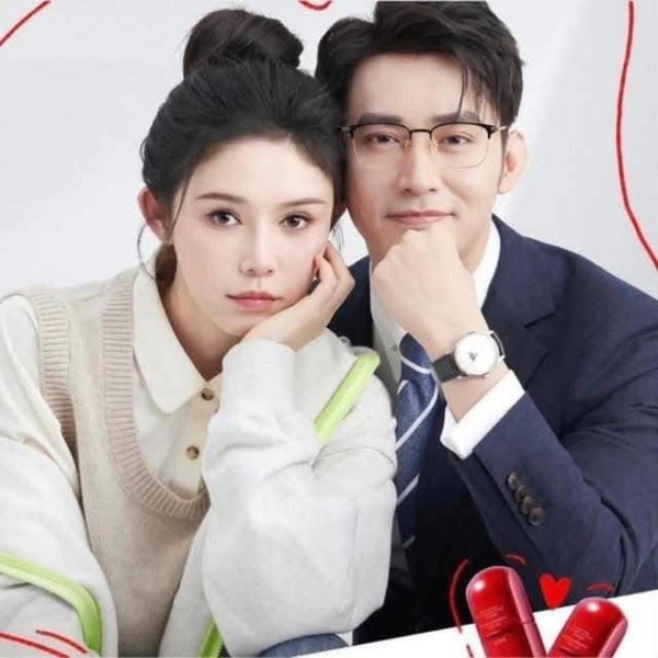 Two people sitting together with a watch on a white background