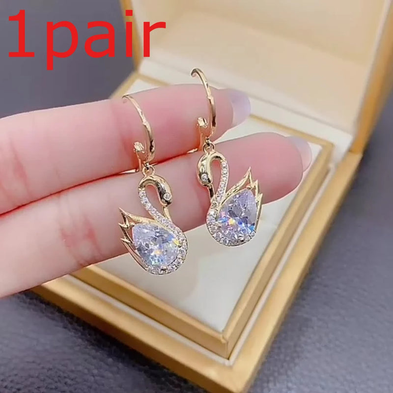 1 Pair of Luxurious Golden-Tone Swan Dangle Earrings with Sparkling Rhinestones - Elegant Zinc Alloy Fashion Jewelry for Women