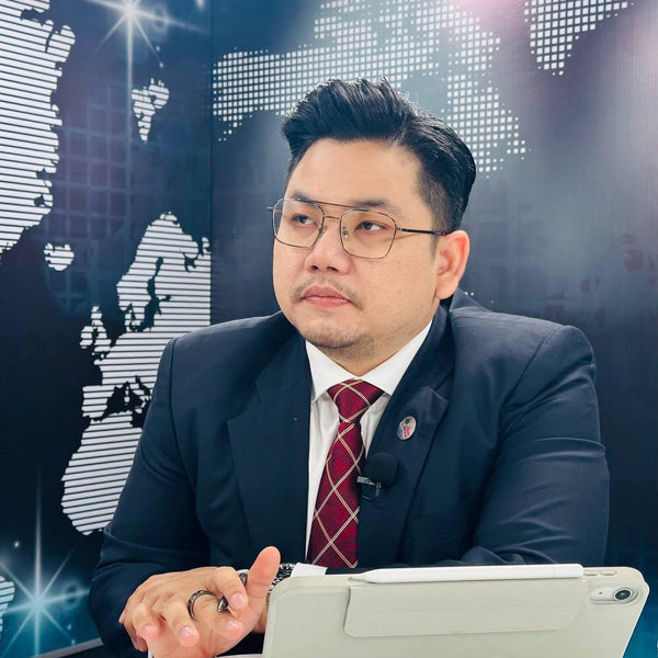 Man in a suit with a world map background