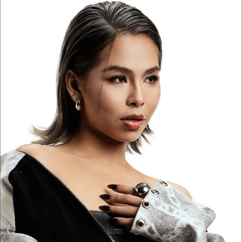 Woman with stylish hair and jewelry on a white background