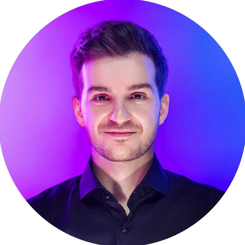 Man wearing a black shirt with a purple circular background