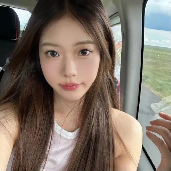 Woman sitting inside a car with a scenic view outside